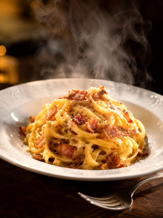 Carbonara fumante appena impiattata, col vapore che sale dal piatto